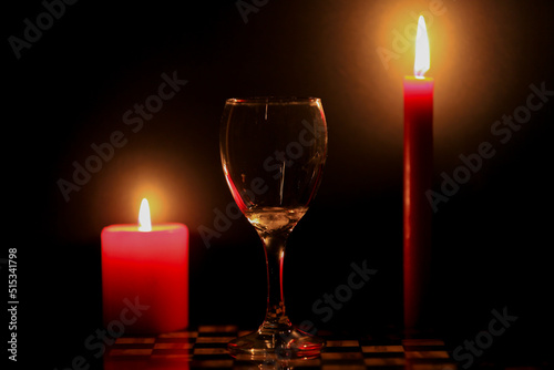 Two candles and a glass of iced water