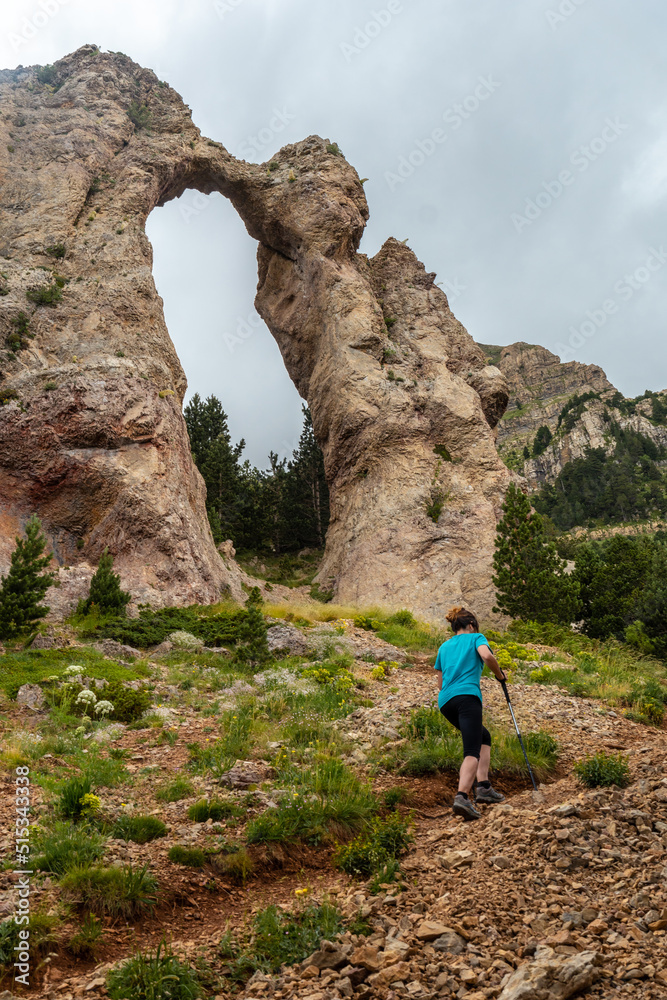 A young man at the Piedrafita arch in the Pyrenees in Biescas, Alto Gallego, Huesca province