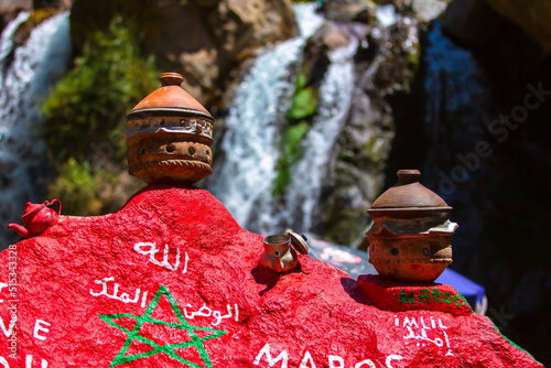 Two moroccan Tajines in front of a big waterfall in Imlil Morocco photo