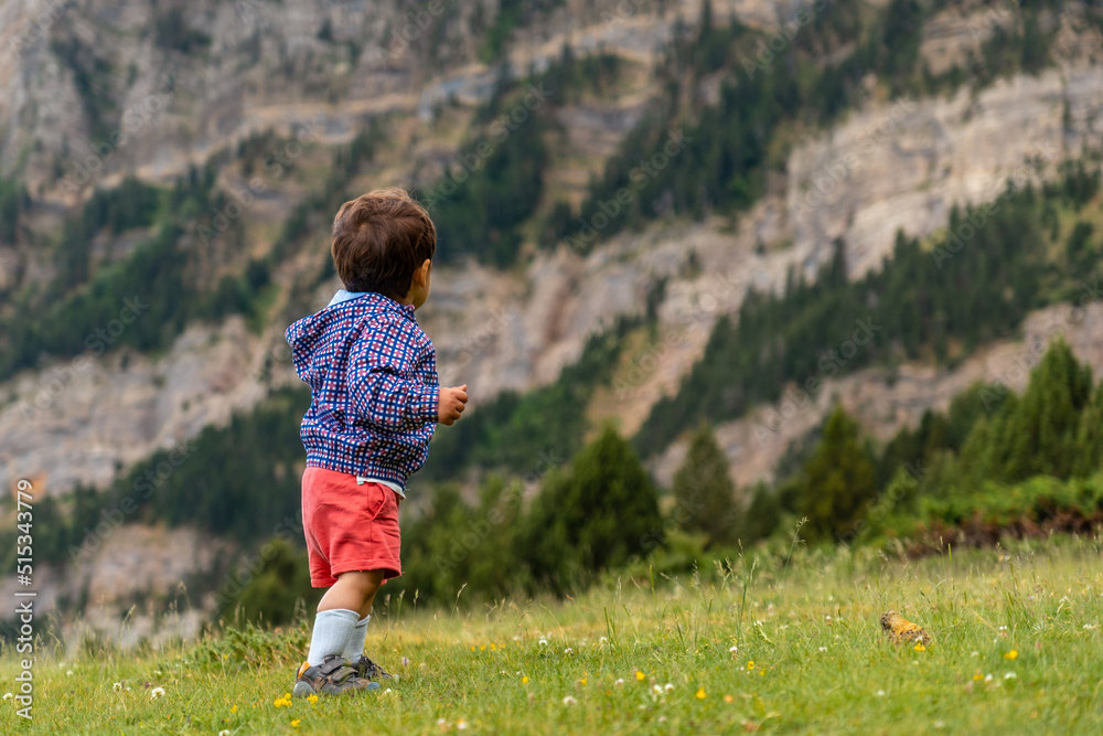 A one year old baby in nature in the Tena valley in the Pyrenees, Huesca, Spain A one year old baby in nature in the Tena valley in the Pyrenees, Huesca, Spain