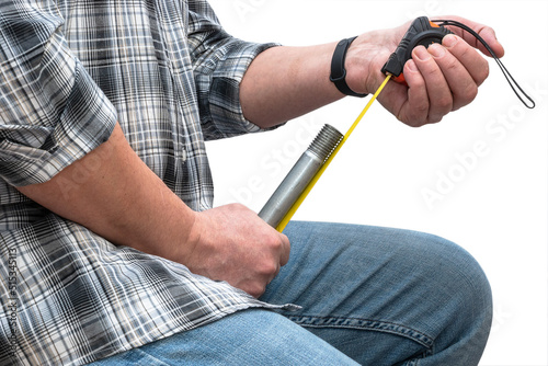 A man measures the length of a penis. The concept of sexual complexes