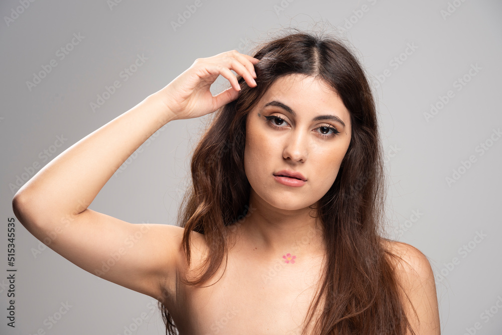 Portrait of beautiful young woman standing and looking at camera Portrait of beautiful young woman standing and looking at camera