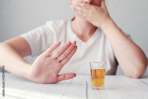 glass of alcohol and a woman's hand no