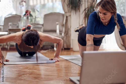 Wallpaper Mural Pretty women working out at home. Adult ladies with beautiful shaped bodies exercising in the apartment. Torontodigital.ca