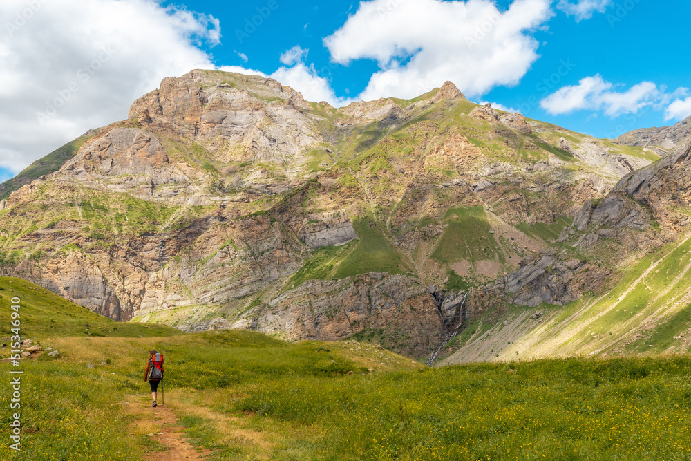 A young woman on mountain trekking with her son in the Ripera valley in summer, Pyrenees
