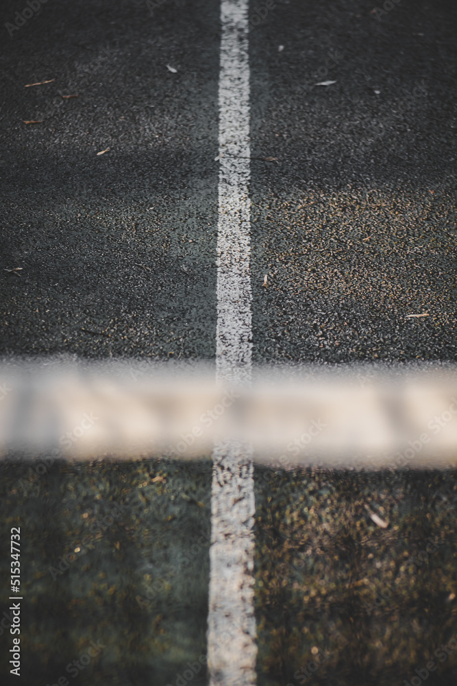 Selective focus shot of a tennis court under the sunlight