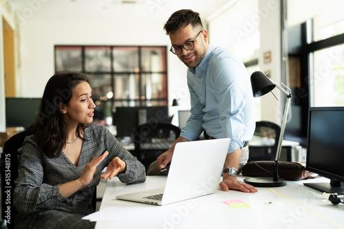 Colleagues in office. Businesswoman and businessman discussing work in office..