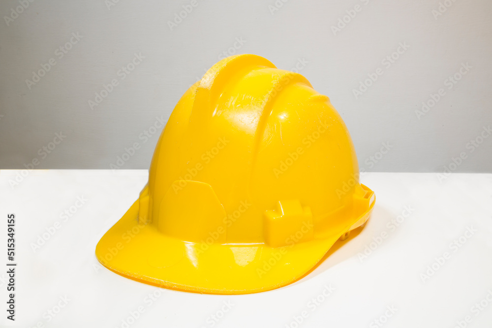 Fototapeta premium Closeup of a yellow safety hat isolated on white background.