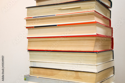 Stack of old books on white background.