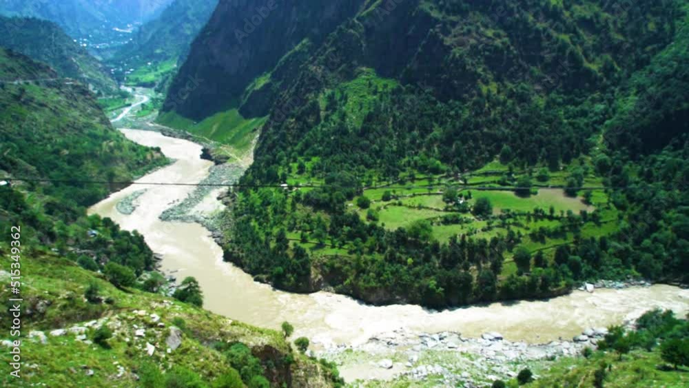 Slow motion shot of river with lush green mountains in hilly area of Pakistan at evening. Slow motion shot of river with lush green mountains in hilly area of Pakistan at evening.