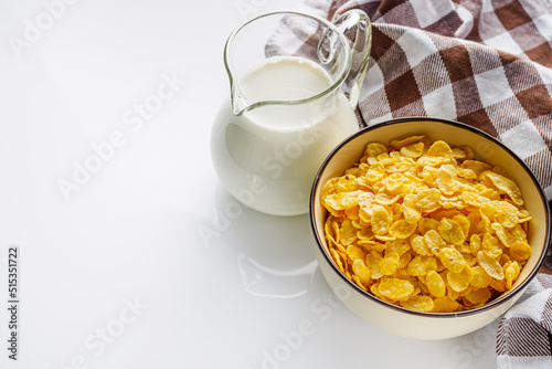 crispy golden cornflakes on a white acrylic background
