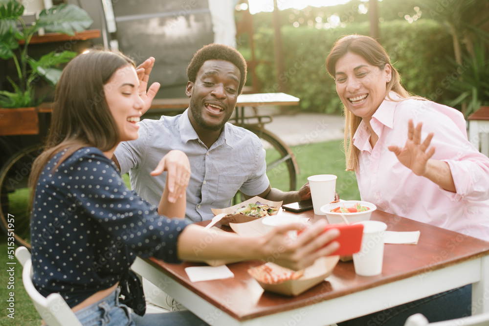 Multiethnic friends making video call during lunch Multiethnic friends making video call during lunch