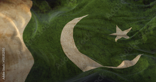 Old Pakistan Flag waving at wind photo