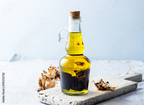 Olive oil bottle on wooden board photo