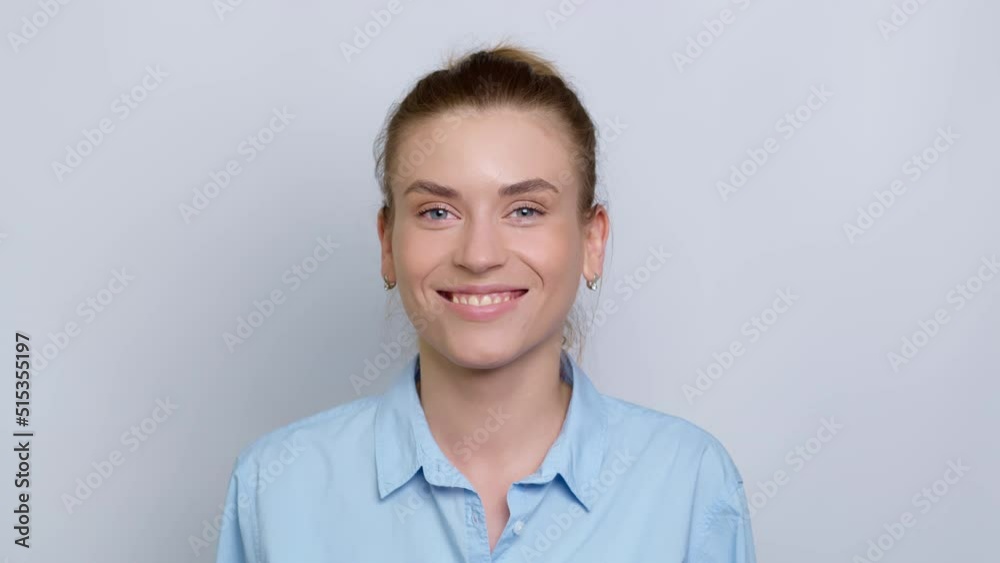 Portrait of a smiling young woman in a shirt on a white background. Happy girl manager looks at the camera.