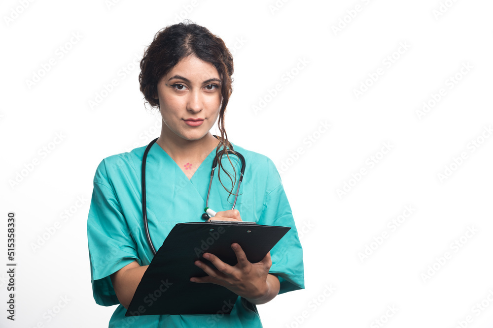 Female doctor with stethoscope writes something in a clipboard on white background Female doctor with stethoscope writes something in a clipboard on white background