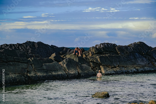 Children swimming at The Tanks tourist attraction natural rock pool at Forster, NSW Australia