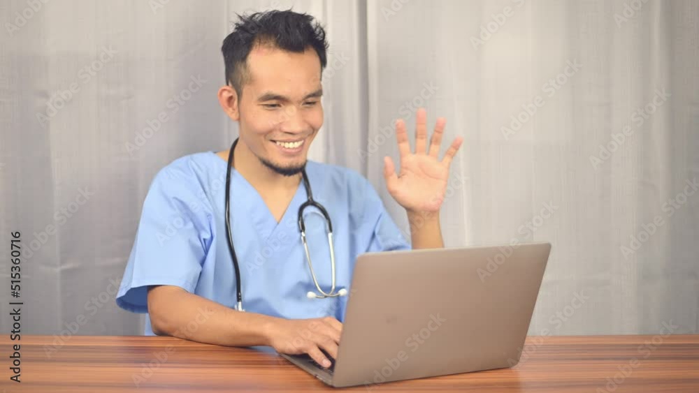 Asian doctor working laptop computer in office at hospital, doctor physician talking, consulting patient online by webcam video call on laptop computer. Asian doctor working laptop computer in office at hospital, doctor physician talking, consulting patient online by webcam video call on laptop computer.