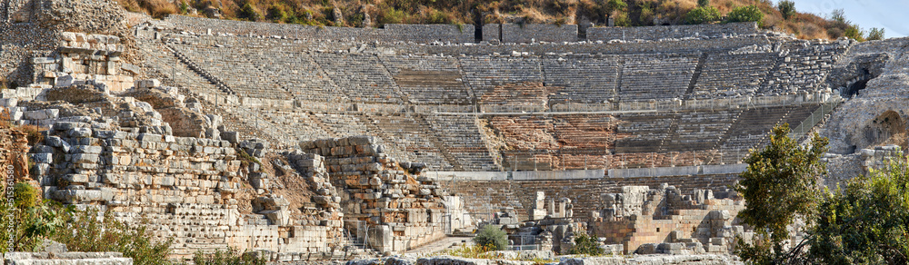Ancient amphitheatre ruins in the city of Ephesus, Turkey. Traveling abroad or overseas for holiday, vacation and tourism. Excavated remains of historical building stone from Turkish history