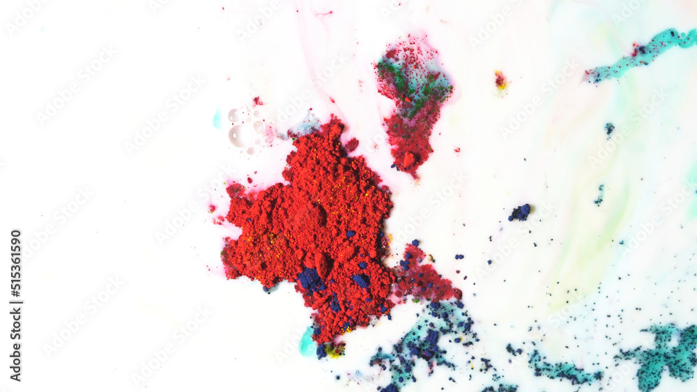 Red powder inks floating on milky liquid. Dry paints moving chaotically on liquid white background.