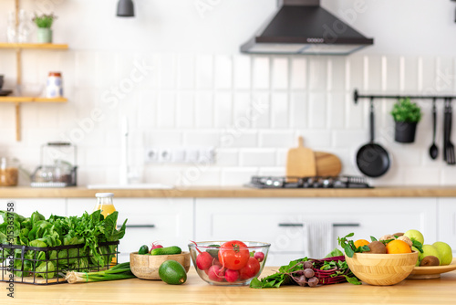 Kitchen table with various fresh vegetables and fruits for healthy and diet food with space for your product or text