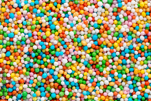Thousands sprinkles tiny sugar beads for decorating cakes and desserts background. © gitusik