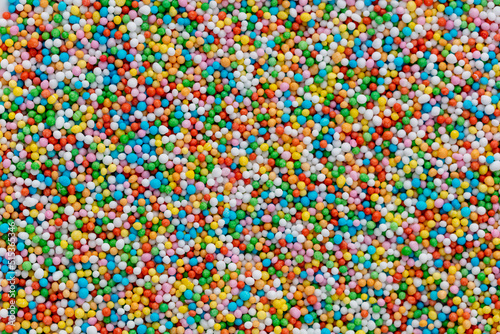 Thousands sprinkles tiny sugar beads for decorating cakes and desserts background.