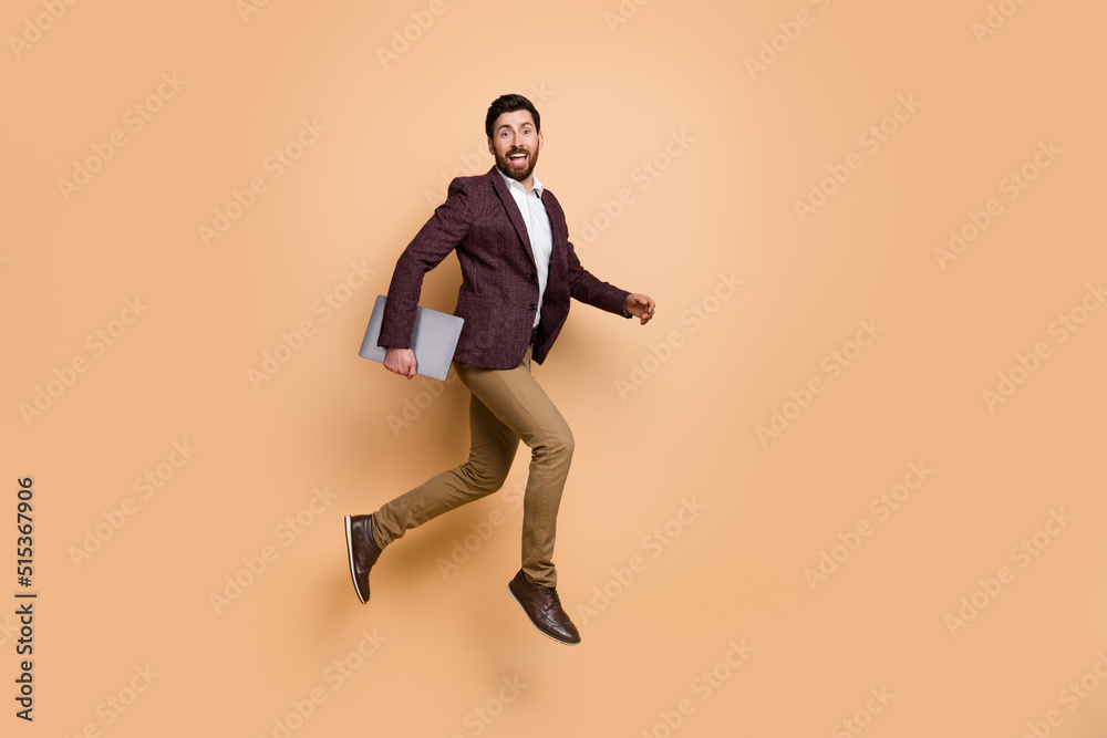 Full size image of young businessman working in city center office company go to work isolated on beige color background Full size image of young businessman working in city center office company go to work isolated on beige color background