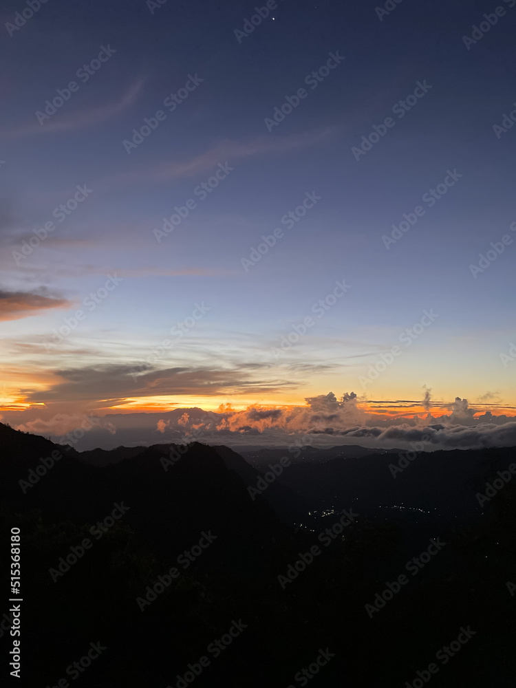 View from the top of the mountain with beautiful clouds and sunshine View from the top of the mountain with beautiful clouds and sunshine