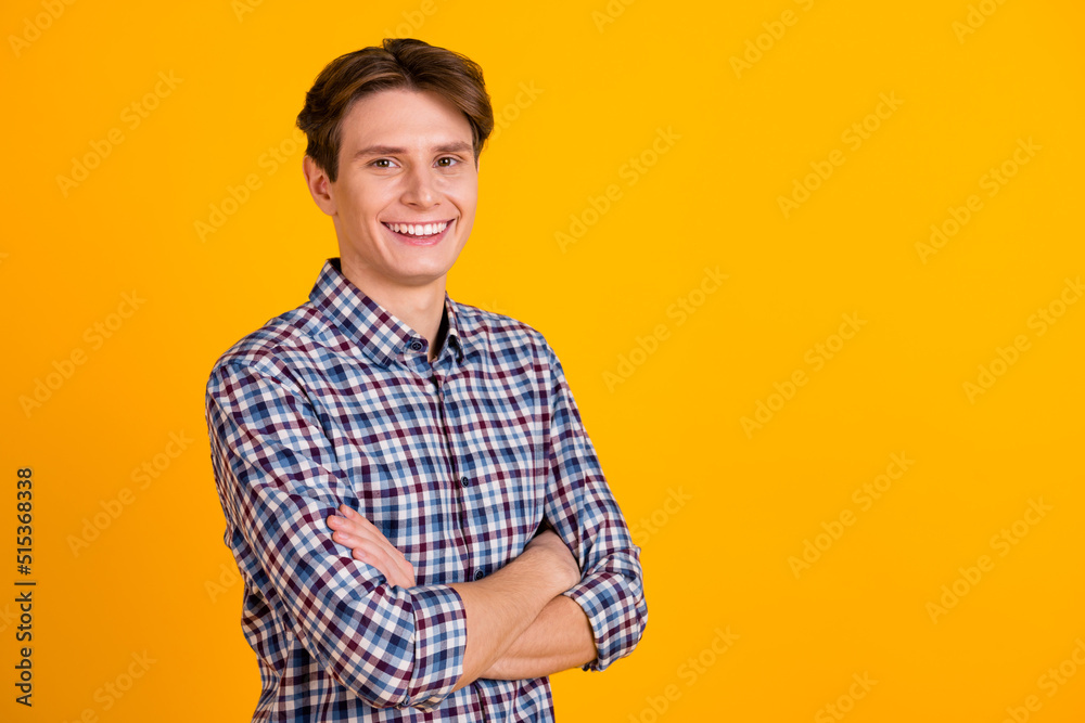 Photo of young cheerful man happy positive smile agent manager crossed hands isolated over yellow color background