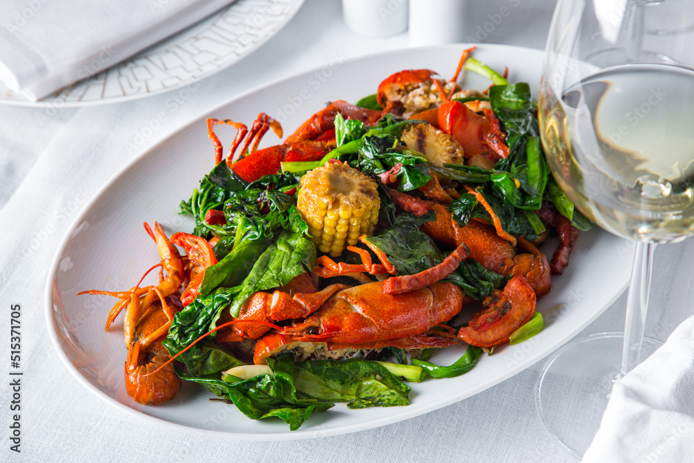 Boiled crayfish with a side dish and a glass of white wine. Boiled crayfish with a side dish and a glass of white wine.