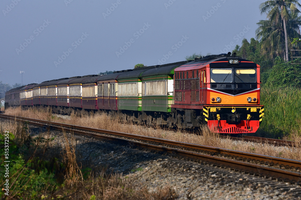 Thai passenger train by diesel locomotive on the railway Thai passenger train by diesel locomotive on the railway