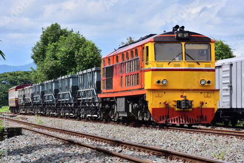Thai hopper freight-train by diesel locomotive on the railway