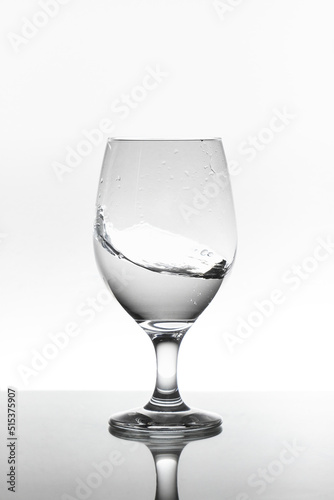 moving water inside a glass cup Isolated on white background