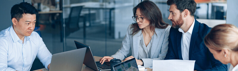 Creative business people working on project in modern office with panoramic view