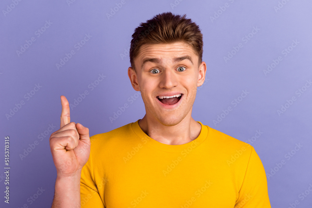 Photo of young excited guy indicate finger clever choose plan creative isolated over violet color background Photo of young excited guy indicate finger clever choose plan creative isolated over violet color background