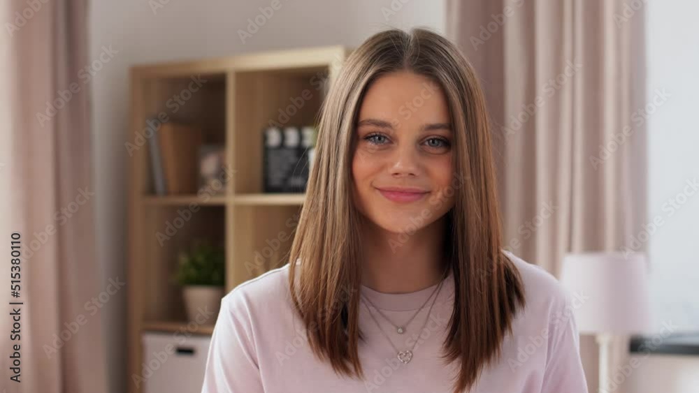 people concept - portrait of happy teenage girl at home
