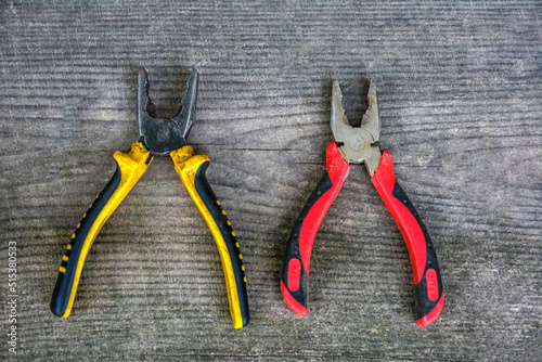 Fotografi Old pliers with plastic handles.