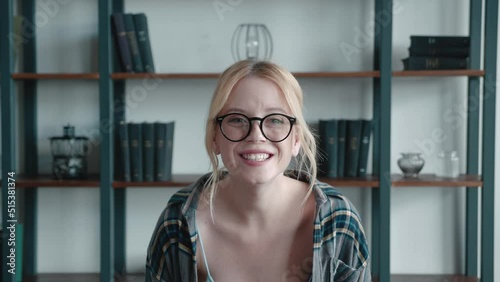 Closeup of surprised excited blonde young woman in checkered shirt and glasses opening her mouth in amazement, shouting Wow, astonished by sudden shocking news, expressing disbelief. photo