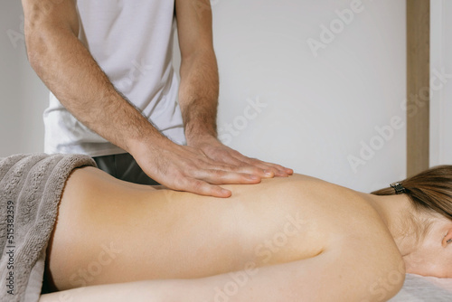 Top view close up of massage hands massing female back skillfully