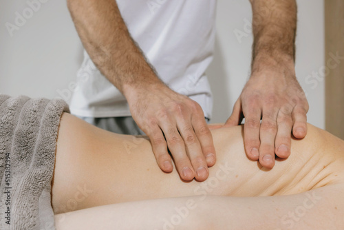 Top view close up of massage hands massing female back skillfully