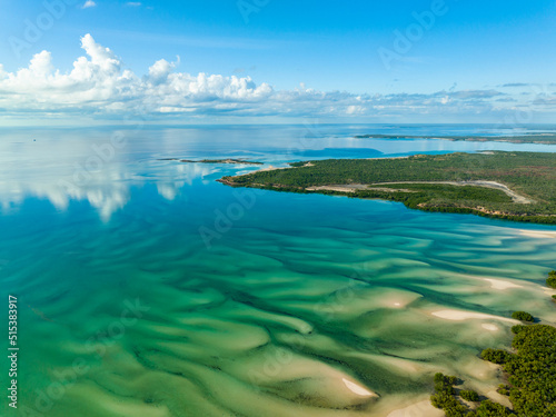 Aerial view over turquoise water and sand waves at Catamaran Bay in the Kimberley of Western Australia