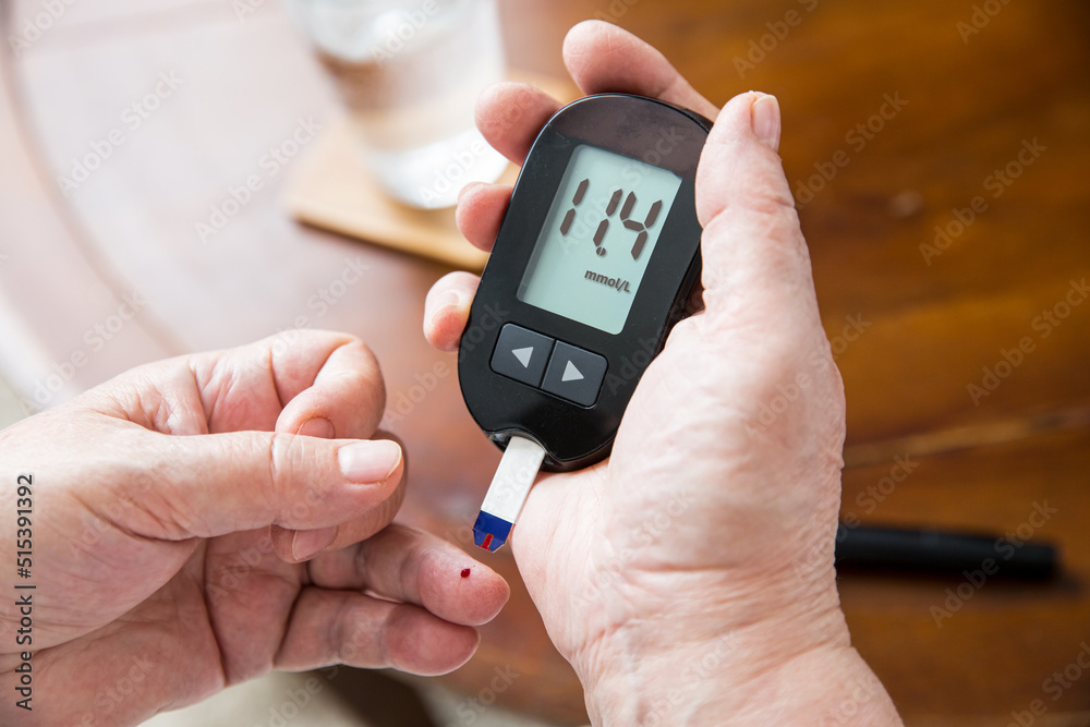 Senior woman checking blood sugar level using home glucometer. Close-up hand of old person with diabetes. Diabetes treatment for elderly people. Senior woman checking blood sugar level using home glucometer. Close-up hand of old person with diabetes. Diabetes treatment for elderly people.