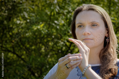 Person practicing EFT. Female tapping karate chop point. Nature background. photo