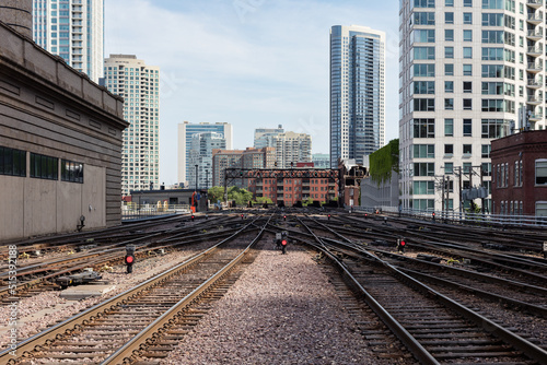 Commuter train tracks cutting between buildings in downtown Chicago