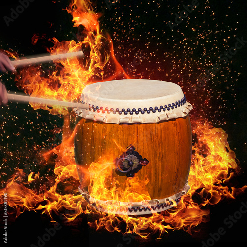 Japanese taiko drum with dancing flames on black background