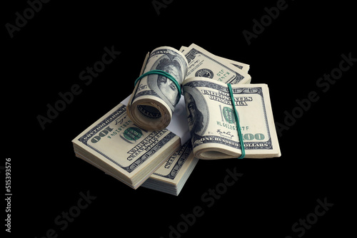 Bundle of US dollar bills isolated on black. Pack of american money with high resolution on perfect black background photo