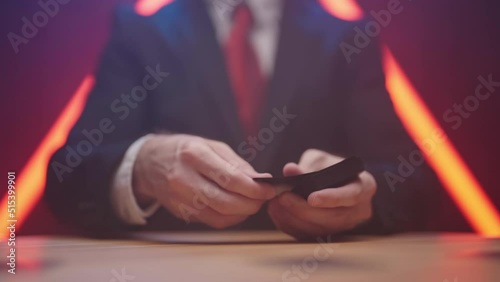Businessman dealing black cards around the table in slow motion 4K