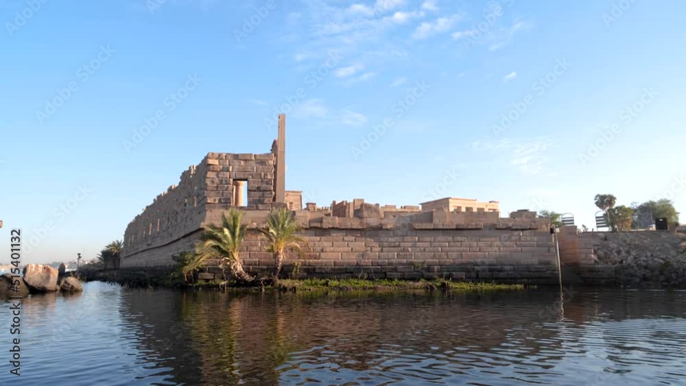 Ancient temple of Philae from a boat during sunrise in Aswan, Egypt. Ancient temple of Philae from a boat during sunrise in Aswan, Egypt.
