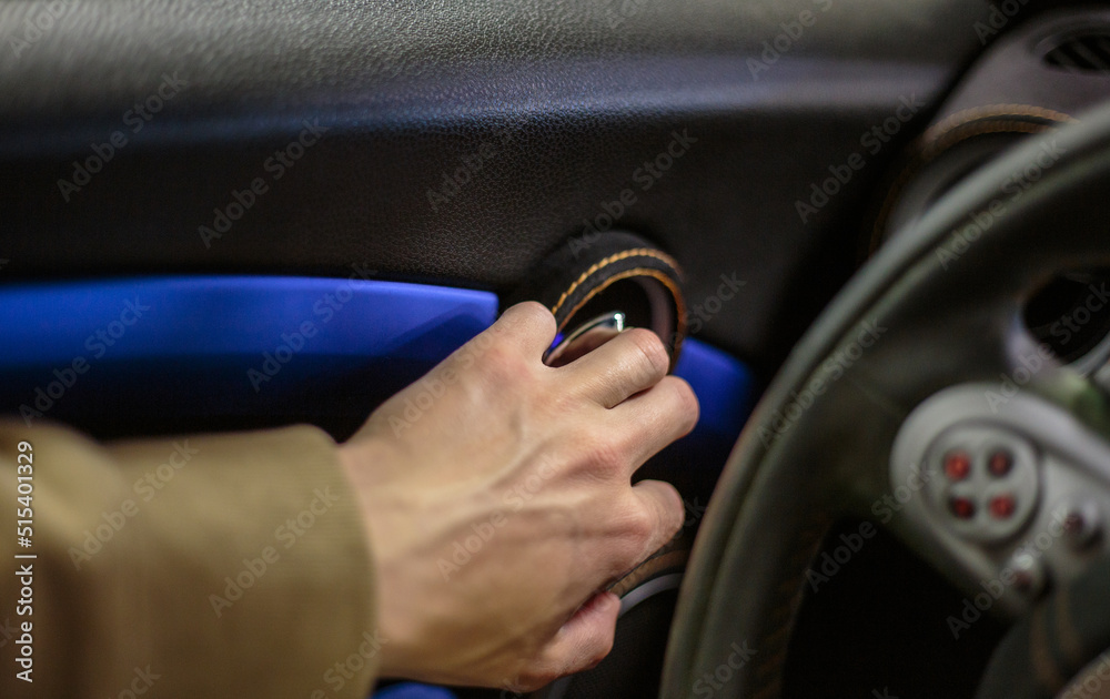 Close-up of a man's hand on the handle of the car door opener. A man opens the doors from inside the interior of a luxury car selective focus.